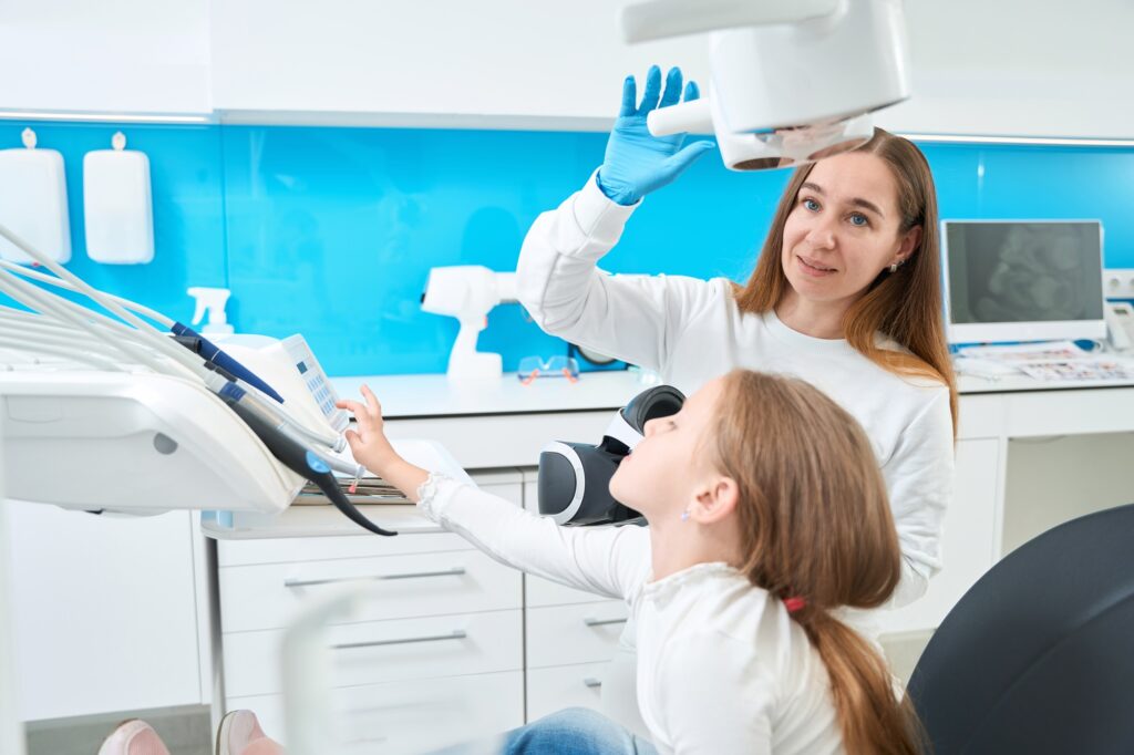 Pediatric dentist preparing to examine little patient teeth
