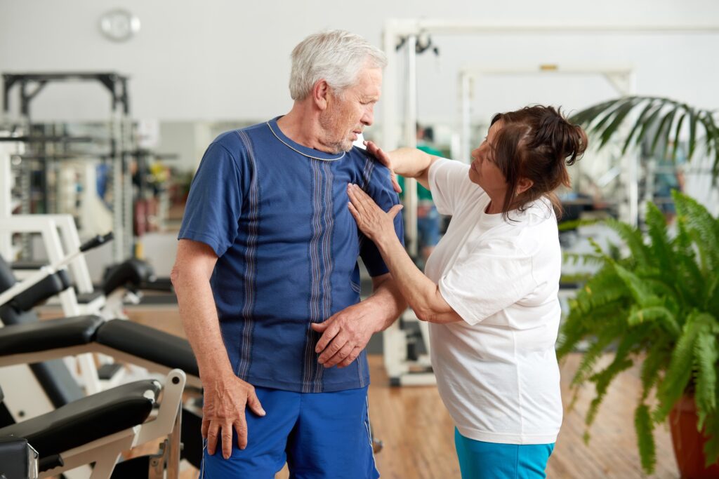 Senior man suffering from shoulder pain during training